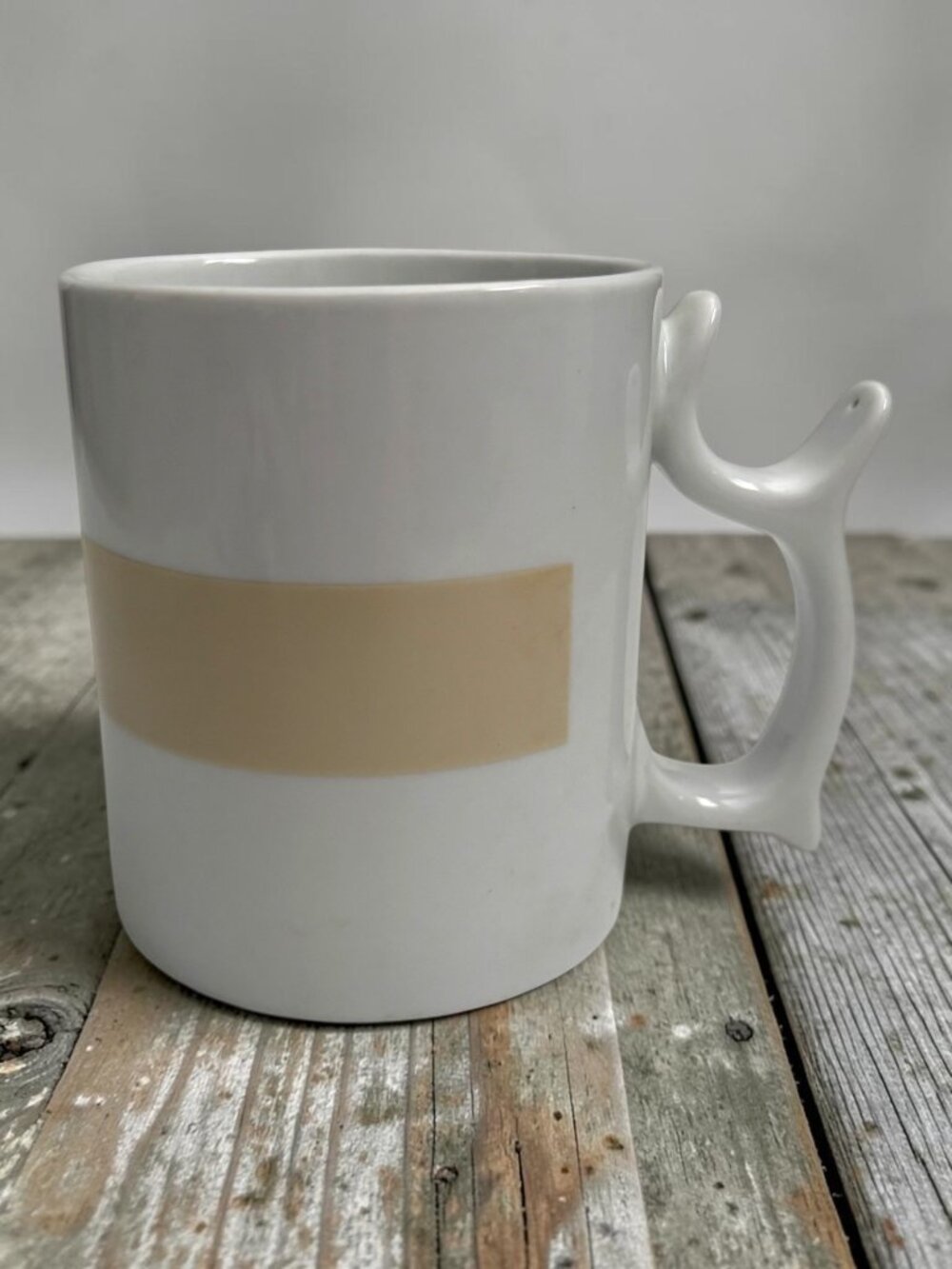 Spinners White Ceramic Mug With Unique Handle Design & Beige Accent Band
